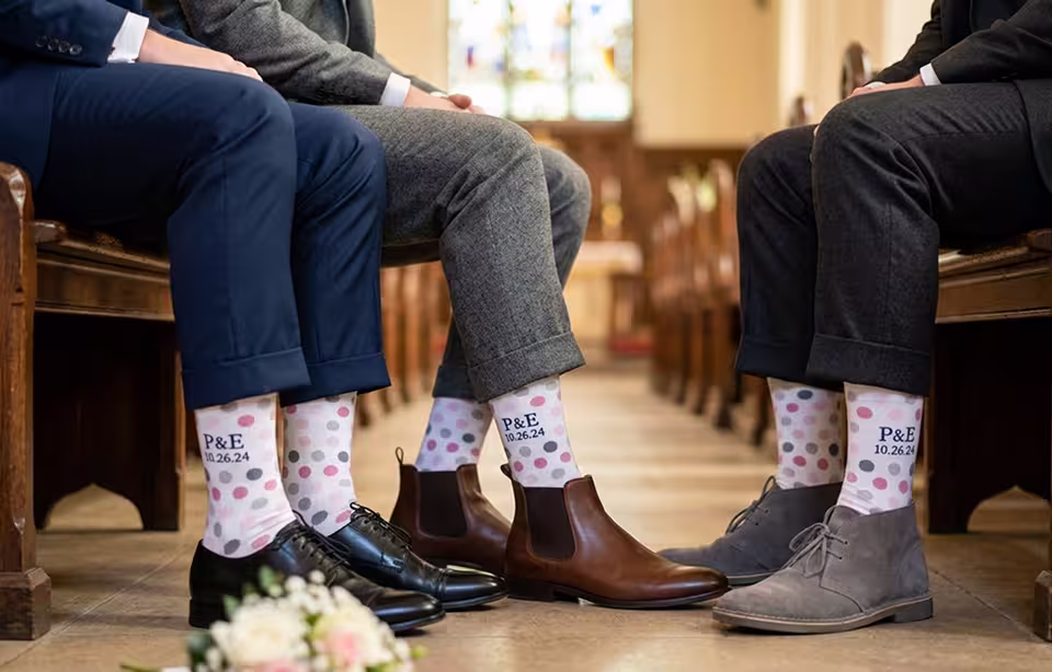 Groomsmen showing off polka dot socks